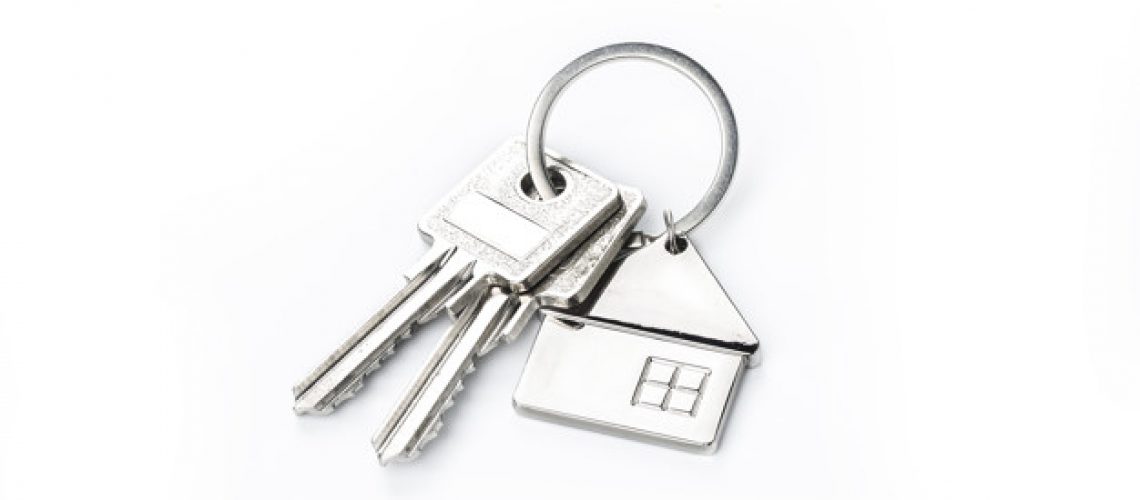 Key placed on top of white background，Purchase concept