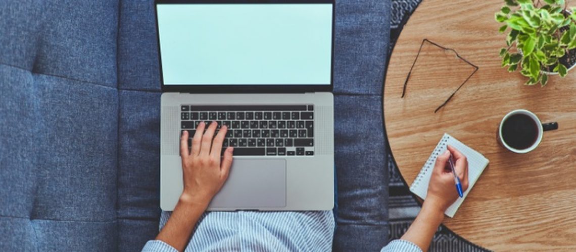 top-view-woman-working-online-laptop-writing-notes-notebook_122732-3546